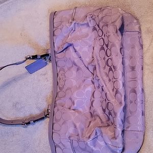 A purple shoulder coach bag